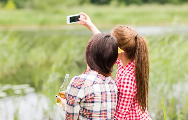 Happy women taking selfie by smartphone — Stock Photo, Image