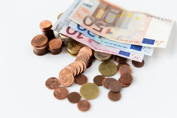 Close up of euro paper money and coins on table — Stock Photo, Image