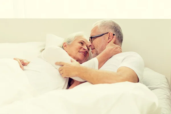 Happy senior coupler lying in bad — Stock Photo, Image