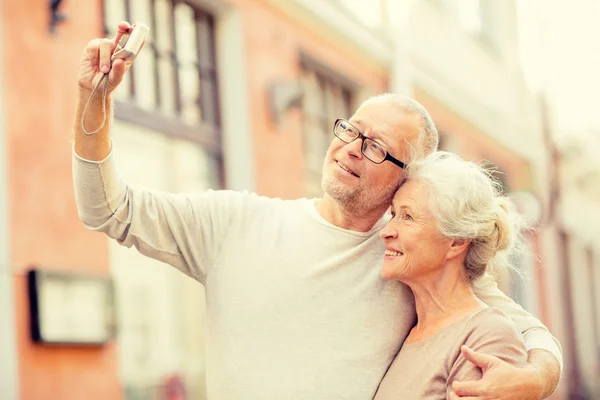 Senior couple photographing on city street — Stock Photo, Image