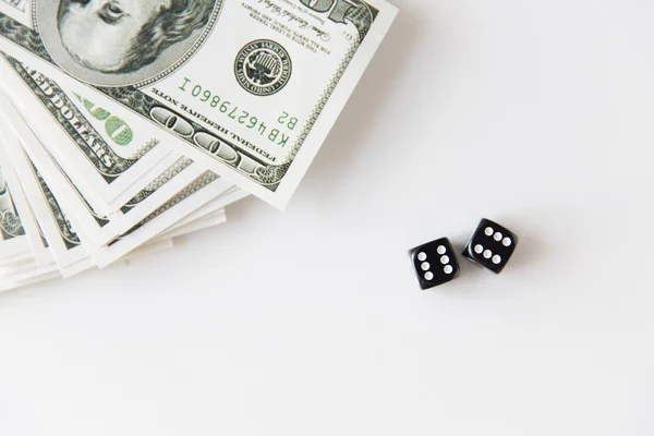 Close up of black dice and dollar money on table — Stock Photo, Image