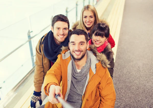 Happy friends taking selfie on skating rink — Stock Photo, Image