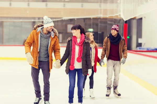 Happy friends on skating rink — Stock Photo, Image