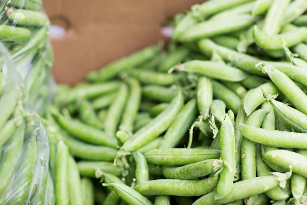 Gros plan de pois verts en boîte au marché de rue — Photo