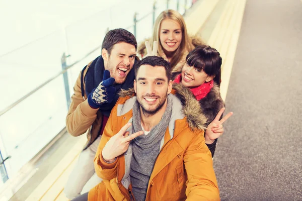 Friends taking selfie on skating rink — Stock Photo, Image