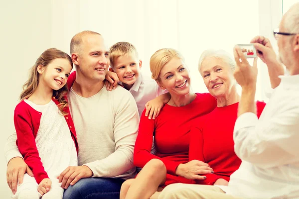 Smiling family with camera at home — Stock Photo, Image