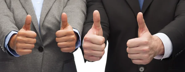 Businessman and businesswoman showing thumbs up — Stock Photo, Image