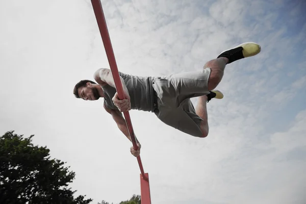 Young man exercising on horizontal bar — Stock Image Young man exercising on horizontal bar Royalty Free Stock Photos