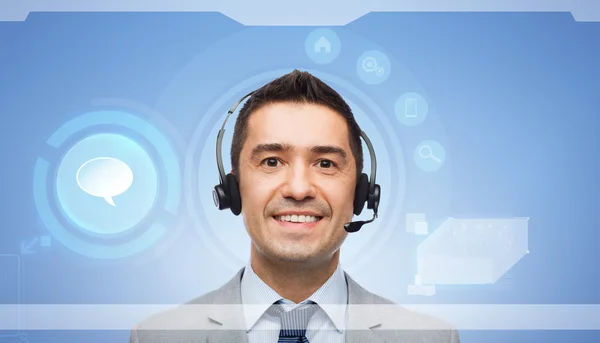 Hombre de negocios sonriente con auriculares —  Fotos de Stock