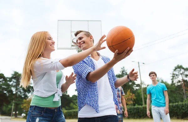 Group of happy teenagers playing basketball — Stock Photo, Image