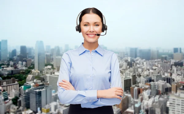 Helpline operator in headset over city background — Stock Photo, Image