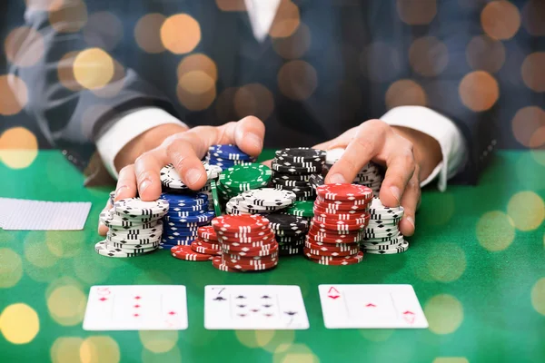 Poker player with cards and chips at casino — Stock Photo, Image