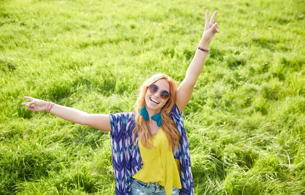 Усміхнена молода хіпі жінка танцює на зеленому полі — стокове фото
