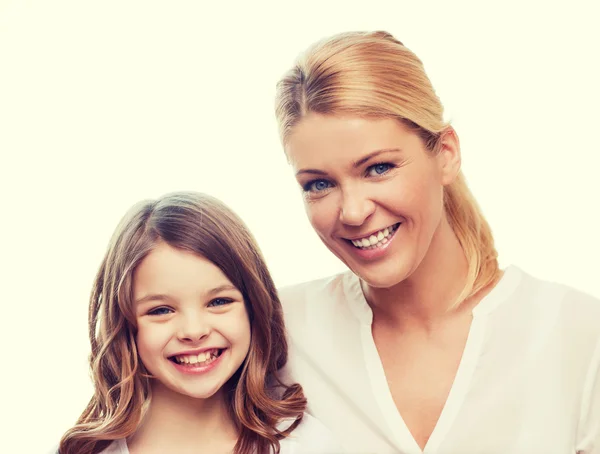 Smiling mother and little girl at home — Stock Photo, Image