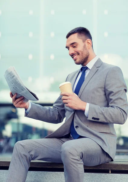Young businessman with coffee and newspaper — Stock Photo, Image