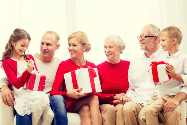 Smiling family with gifts at home — Stock Photo, Image