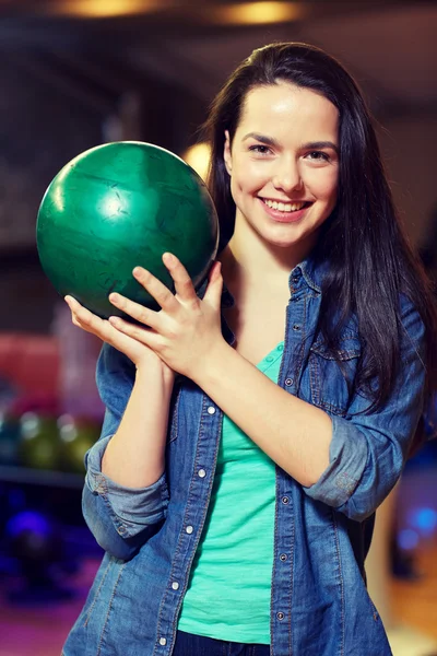 Glückliche junge Frau hält Ball im Kegelclub — Stockfoto