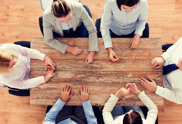 Business team sitting at table — Stock Photo, Image