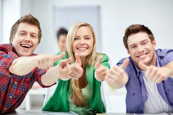 Group of happy students showing thumbs up — Stock Photo, Image