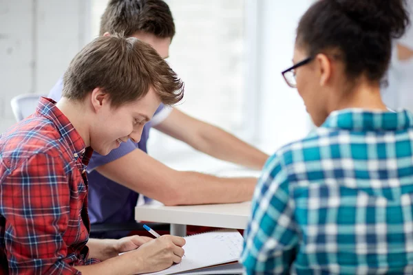 Group of happy high school students with workbook — Stockfoto