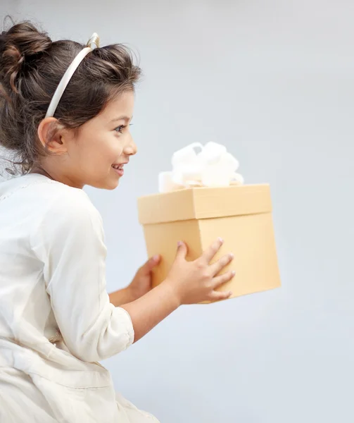 Glückliches kleines Mädchen mit Geschenkbox zu Hause — Stockfoto