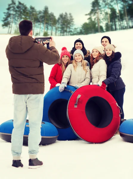 Group of smiling friends with snow tubes — Stock Photo, Image