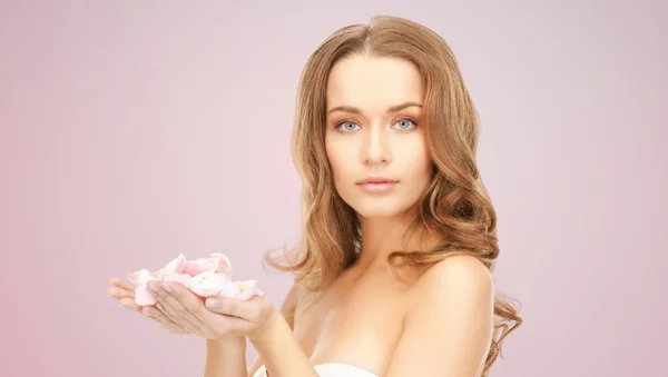 Beautiful smiling young woman with flower petals — Stock Photo, Image