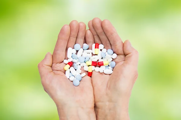 Close up of senior woman hands with pills — Stock Photo, Image