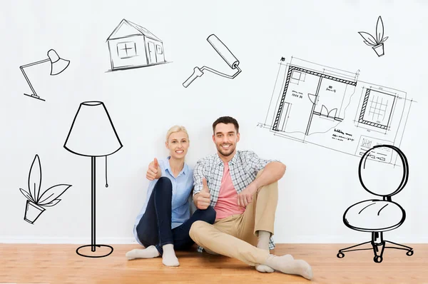 Couple heureux montrant pouces vers le haut à la nouvelle maison — Photo