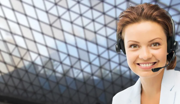 Helpline operator in headset over grid background Stock Picture