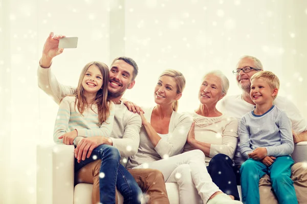 Happy family taking selfie with smartphone at home — Stock Photo, Image