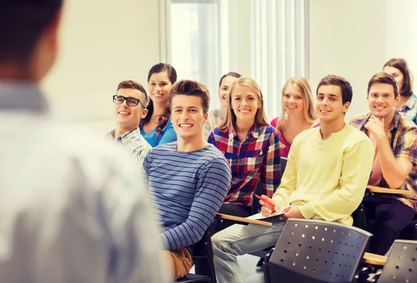 Group of students and teacher with notebook — Stock Photo, Image