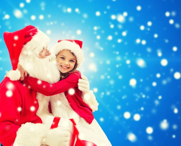 Smiling little girl with santa claus — Stock Photo, Image