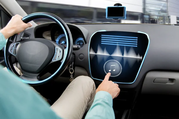 Close up of man driving car with audio system — Stock fotografie