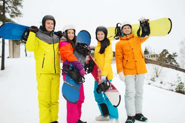 Glückliche Freunde in Helmen mit Snowboards im Freien — Stockfoto