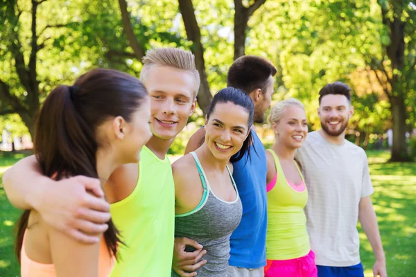 Grupp med glada vänner eller idrottsmän utomhus — Stockfoto