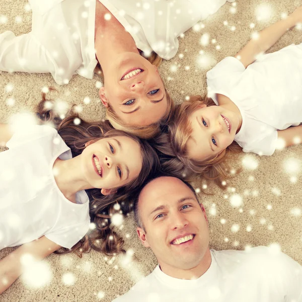 Parents and two girls lying on floor at home — Stock Photo, Image