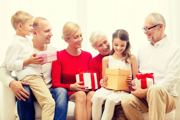 Smiling family with gifts at home — Stock Photo, Image