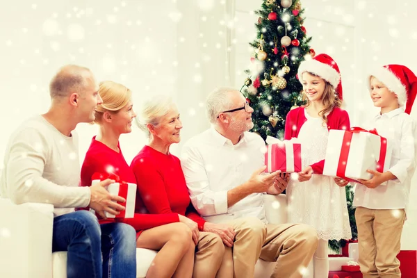 Familia sonriente con regalos en casa — Foto de Stock