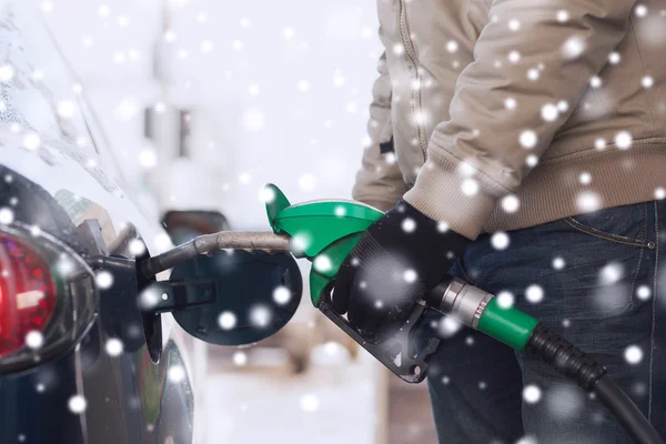 Close up of man with fuel hose nozzle tanking car — Stock Photo, Image