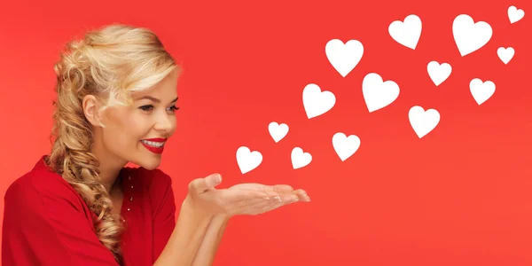 Woman sending heart shapes from palms of her hands — Stockfoto