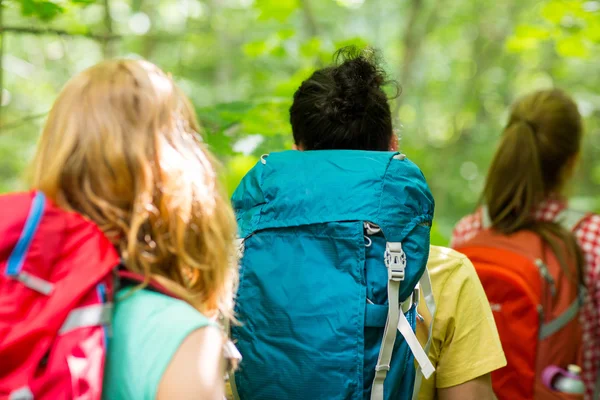 Close up of friends with backpacks hiking — Stock Photo, Image