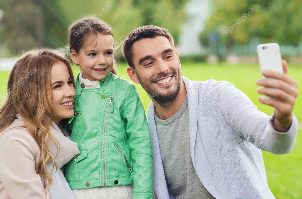 Happy family taking selfie by smartphone outdoors — Stock Photo © Syda