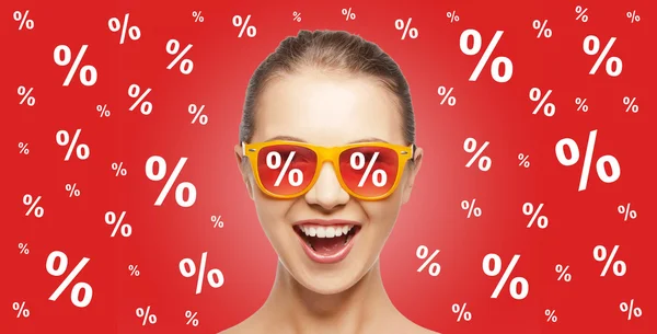 Happy teenage girl in shades with percentage signs — Zdjęcie stockowe