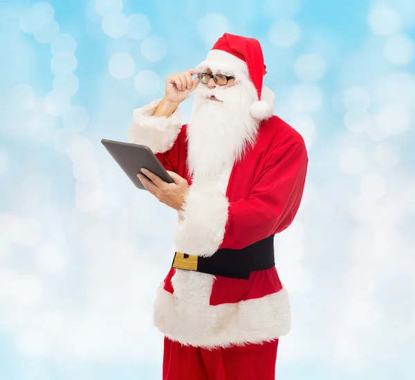 Man in costume of santa claus with tablet pc — Stock Photo, Image