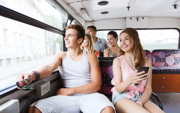 Happy teenage friends traveling by bus — Stock Photo, Image