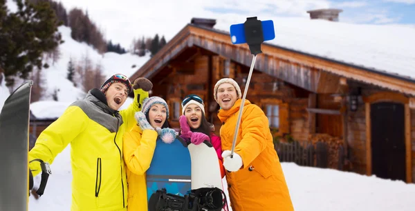 happy friends with snowboards and smartphone