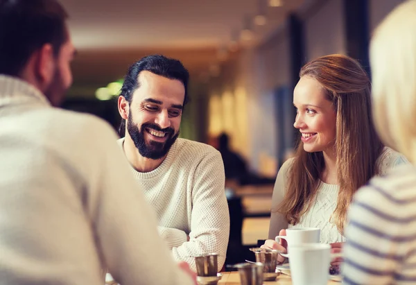Happy friends meeting and drinking tea or coffee — Stock Photo, Image