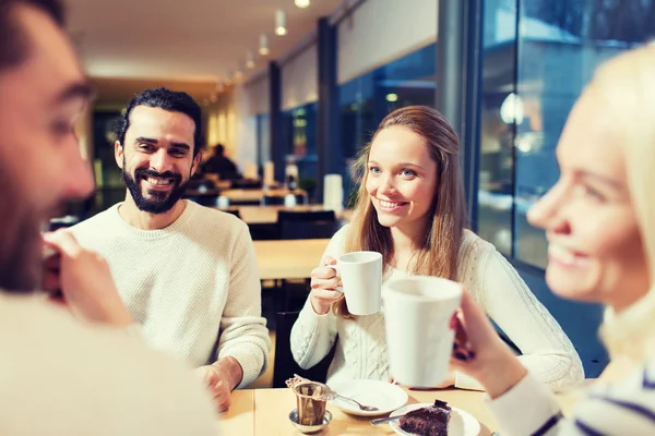 Happy friends meeting and drinking tea or coffee — Stock Photo, Image