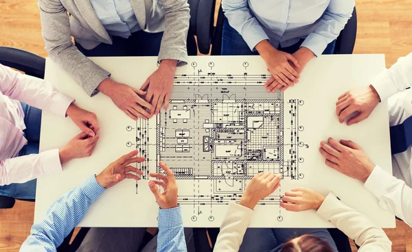 Close up of business group with blueprint — Stock Photo, Image